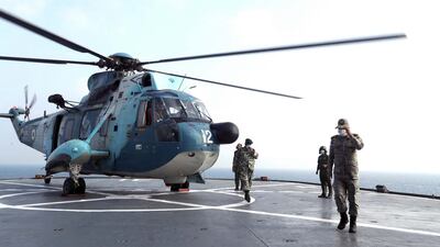 A handout photo made available by Iranian Army website shows an Iranian helicopter lands on a warship during a military exercise in the Arabian Gulf in September, 2020. EPA