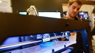Visitors look at a 3D printer printing an object, during "Inside 3D Printing" conference and exhibition in New York. There are only a handful of 3D printer suppliers in the rMiddle East. AFP PHOTO/Emmanuel Dunand