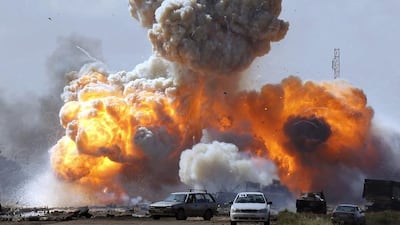 Vehicles belonging to forces loyal to Libyan leader Muammar Gaddafi are hit by a coalition air strike in 2011. Goran Tomasevic / Reuters