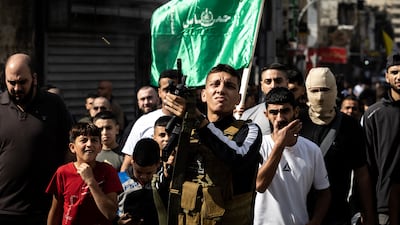 A man fires in the air as Palestinian mourners attend the funeral of men killed in an overnight Israeli army raid in the Jenin refugee camp. AFP