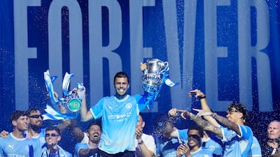 Manchester City midfielder Rodri, centre, with the FA Cup and League Cup - the last two trophies the club won under Pep Guardiola. PA