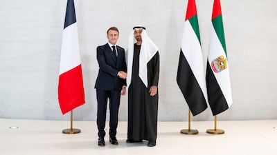 Sheikh Mohamed and Mr Macron with their two countries' flags at the Zayed National Museum on Saadiyat Island