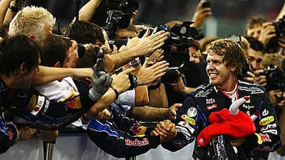 Sebastian Vettel is congratulated after taking the chequered flag at Yas Marina Circuit to win the Abu Dhabi GP and the drivers’ title.
