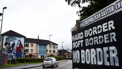 A car drives past a sign saying 'No Border, Hard border, soft border, no border' in Londonderry, Northern Ireland August 16, 2017. Clodagh Kilcoyne/Reuters