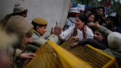A supporter of New Delhi Chief Minister Arvind Kejriwal, argues with police as she demands her right of way past barricades during a demonstration against the police . Altaf Qadri? / AP Photo