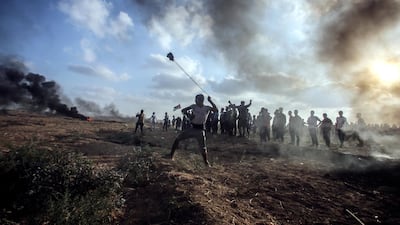 Palestinians take part during the clashes between Israeli troops and Palestinians near the border in the east Gaza City on July 13. EPA