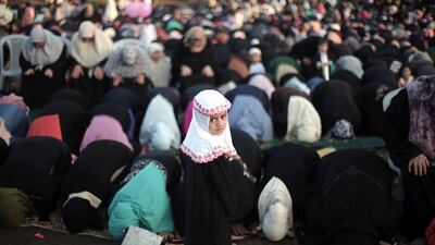 Palestinian Muslims pray to mark the first day of Eid Al Adha in Gaza City. Khalil Hamra / AP Photo