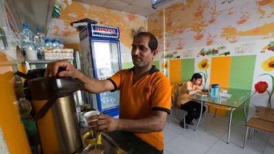 Maarouf P, who works at Al Shama cafeteria beside the National Paints roundabout, says the building work is affecting the business. Jaime Puebla / The National