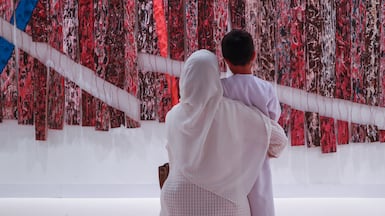 A mother and son look at an artwork at Abu Dhabi Art 2023. The annual event has been rebranded as Frieze Abu Dhabi. Victor Besa / The National