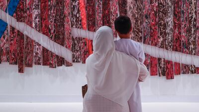 A mother and son look at an artwork at Abu Dhabi Art 2023. The annual event has been rebranded as Frieze Abu Dhabi. Victor Besa / The National