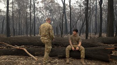 Australian Defence Force (ADF) personnel take a break after arriving in Mallacoota. Getty Images