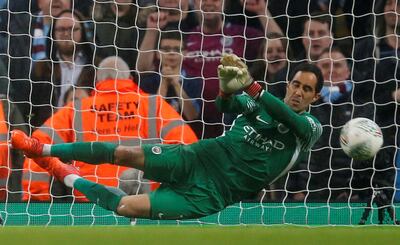 Manchester City's Claudio Bravo saves a penalty during the shoot-out win against Wolves. Andrew Yates / Reuters