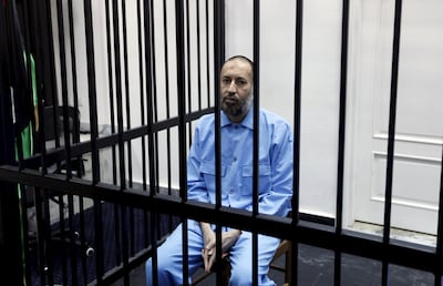 Saadi Gaddafi, son of Muammar Gaddafi, sits behind bars during a hearing at a courtroom in Tripoli in 2016. Reuters, File