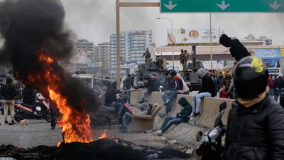 Lebanese anti-government protesters burn tyres to block the road leading to the southern entrance of the northern port city of Tripoli. AFP