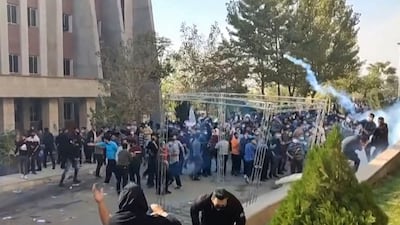 Protesters attempt to dodge projectiles fired at them during clashes at Iran's Islamic Azad University in Tehran. AFP