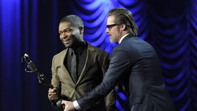 Brad Pitt, right, presents the Breakthrough Performance award to David Oyelowo for Selma at the 26th annual Palm Springs International Film Festival Awards Gala on Saturday, January 3, 2015, in Palm Springs, California. Chris Pizzello / Invision / AP Photo