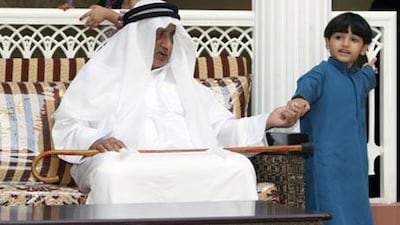 Rashid Saeed al Sori, a resident aged 60, is paid a visit by Abdullah Whaled, five.