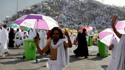 A man shades himself from the sun during his visit to Mount Arafat. Reuters