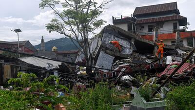 Search and rescue personnel inspect a collapsed building following an earthquake in Mamuju, West Sulawesi province, Indonesia. Reuters