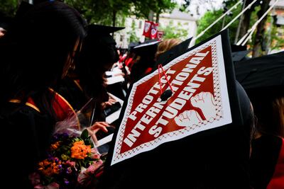 A graduating student wears their hat, decorated with a statement of support for foreign students, at Harvard University. Reuters