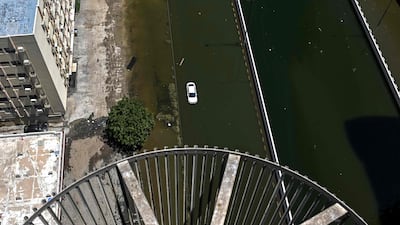 A car is stranded in a flooded street in Sharjah on April 20. AFP