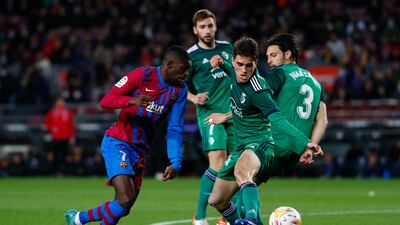 Barcelona winger Ousmane Dembele vies for the ball surrounded of Osasuna players. AP
