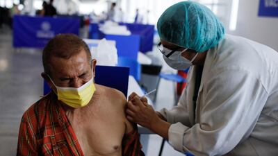 A health worker administers a dose of Sinovac's CoronaVac vaccine at an inoculation centre in San Salvador, El Salvador. Reuters