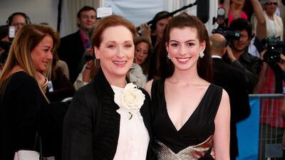 Meryl Streep and Anne Hathaway, in a gold-trimmed LBD, attend 'The Devil Wears Prada' premiere at the 32nd Deauville Festival on September 9, 2006 in Deauville, France. Getty Images