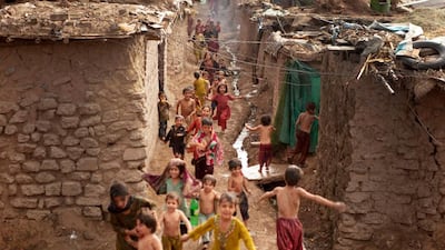 Pakistani children living in Islamabad's slums run in Pakistan, Wednesday, June 27, 2012. (AP Photo/B.K. Bangash)