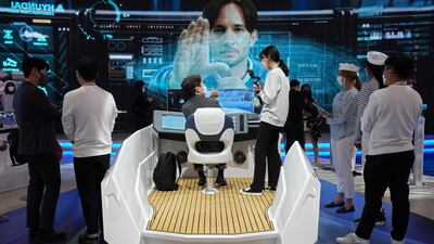 Attendees try out autonomous boat technology at the Hyundai Heavy Industries Group stand at CES 2022. AP Photo