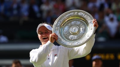 Barbora Krejcikova of the Czech Republic celebrates with the trophy after winning the Wimbledon final against Italy's Jasmine Paolini on Saturday, July 13, 2024. Reuters