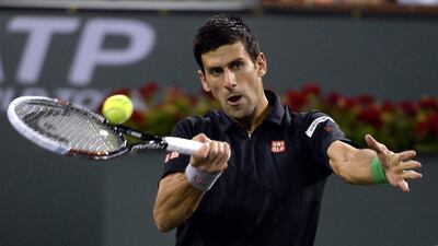 Novak Djokovic hits a return against Victor Hanescu at the Indian Wells Masters on March 9, 2014. Michael Nelson / EPA