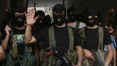Lebanese masked gunmen from the Al Muqdad clan gather for a press conference in Beirut's southern suburbs.