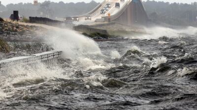 In this Tuesday, August 28, 2012 file photo, waves from the Santa Rosa Sound crash over the Navarre Beach causeway in Navarre, Florida, as Isaac approaches the Gulf Coast. The National Hurricane Center warns that the worst damage from 2017's Hurricane Irma could be from storm surge that could top 12 feet high in some areas of the Florida coast. Nick Tomecek / Northwest Florida Daily News via AP