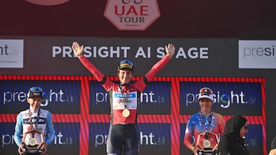 Elisa Longo Borghini of Trek-Segafredo celebrates her overall win in the inaugural UAE Tour Women, flanked by teammate Gaia Realini, left, and Silvia Persico, of UAE Team ADQ, at Abu Dhabi Breakwater on Sunday, February 12, 2023. Photo: LaPresse