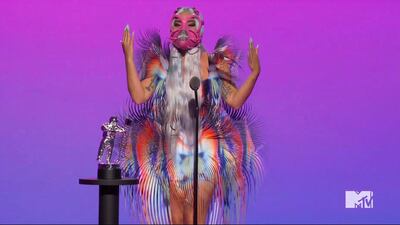 Lady Gaga, in a fringed Iris van Herpen dress and pink mask, accepts the award for Best Collaboration during the MTV Video Music Awards. AP