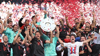 Bayern Munich's Thomas Muller and Manuel Neuer celebrate with the trophy and teammates after winning the Bundesliga title on May 27, 2023. Reuters