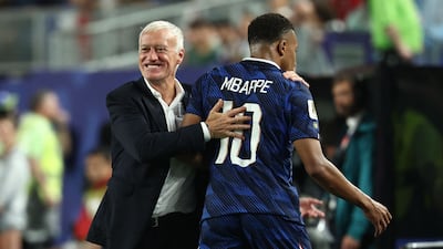 France goalscorer Kylian Mbappe is embraced by head coach Didier Deschamps during their win over Iraq. AFP