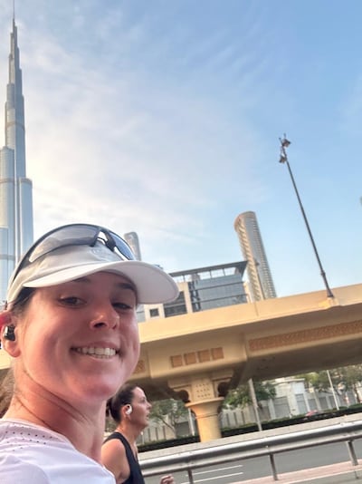 Running in front of the first of the two towers in the Burj2Burj Half Marathon. Farah Andrews / The National