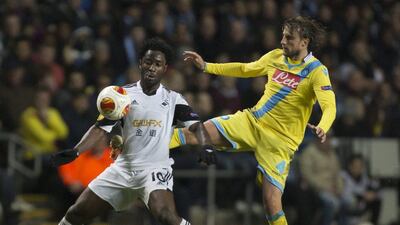 Swansea's Wilfried Bony, left, fights for the ball against Napoli's Henrique during their Uefa Europa League round of 32 first leg soccer match at the Liberty Stadium, Swansea, Wales on February 20, 2014. Jon Super / AP Photo