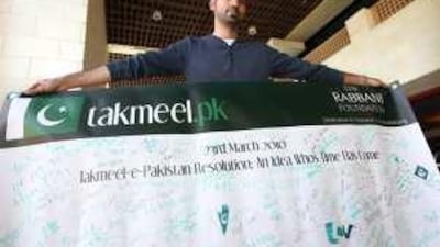Mobisher Rabbani, a campaigner based in Dubai, with a signed poster that he is taking to Pakistan in support of the Takmeel E Pakistan resolution.
