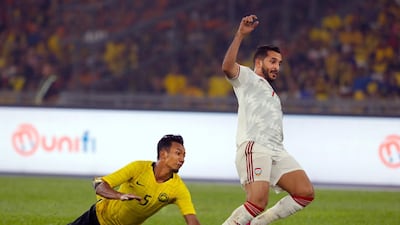 Malaysia's Adam Nor Azlin, left, fights for the ball with UAE's Ali Ahmed Mabkhout. AP