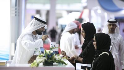 Emirati nationals peruse the jobs, at Tawdheef, a job fair open to UAE citizens only, on Monday, February 2, 2015, at the Abu Dhabi National Exhibition Center. Silvia Razgova / The National