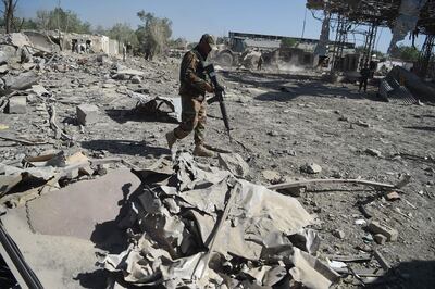 An Afghan soldier investigates the site of a Taliban car bomb attack in Kabul on July 2, a day after the deadly blast at the Defence Ministry's logistics centre. AFP