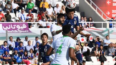 Japan's Takehiro Tomiyasu scores with a header. EPA
