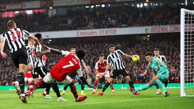 Newcastle goalkeeper Nick Pope saves from Bukayo Saka of Arsenal early in game. Getty