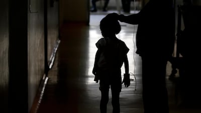 A young dengue patient walks inside the San Lazaro government hospital in Manila.