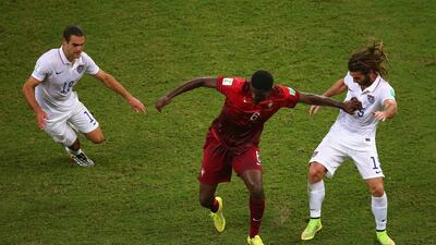 William Carvalho of Portugal takes on Graham Zusi and Kyle Beckerman. Elsa / Getty Images