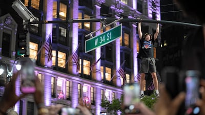 A fan celebrates the New York Knicks' win over the San Antonio Spurs in Game 5 of the NBA Finals, on a street near Madison Square Garden, in New York. Reuters