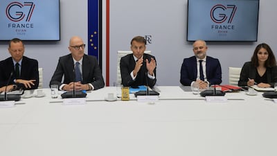 French President Emmanuel Macron speaks with French officials following a video conference with G7 leaders from the Elysee Presidential Palace in Paris. Reuters
